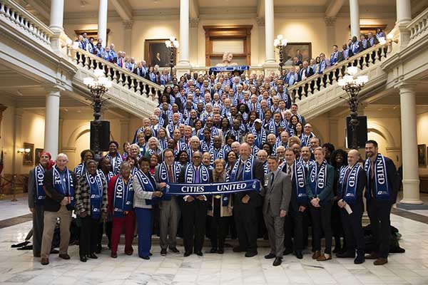 Image of GA state city leaders holding GM Cities United banners.