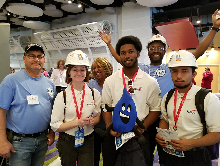 Three students and H2Opportunity representatives from Marietta, Atlanta and Arcadis, Inc. at the "World of Water" booth as part of the 2020 Construction Education Foundation of Georgia Expo.