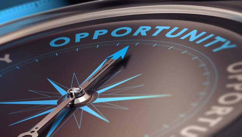 Compass with needle pointing the word opportunity.